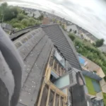Roofing experts repairing cracked tiles on a family home in Kildare.
