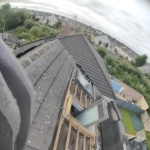 Roofing experts repairing cracked tiles on a family home in Kildare.