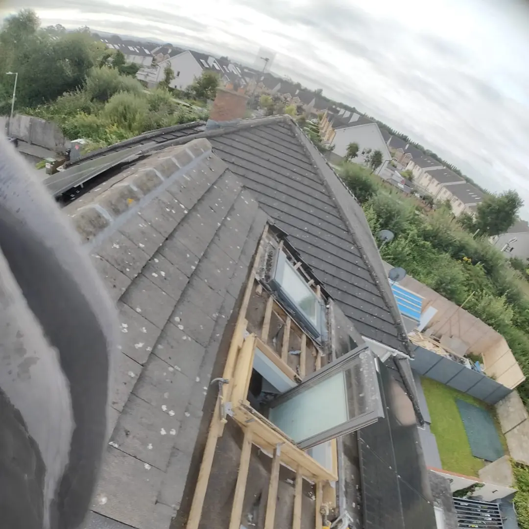 Roofing experts repairing cracked tiles on a family home in Kildare.