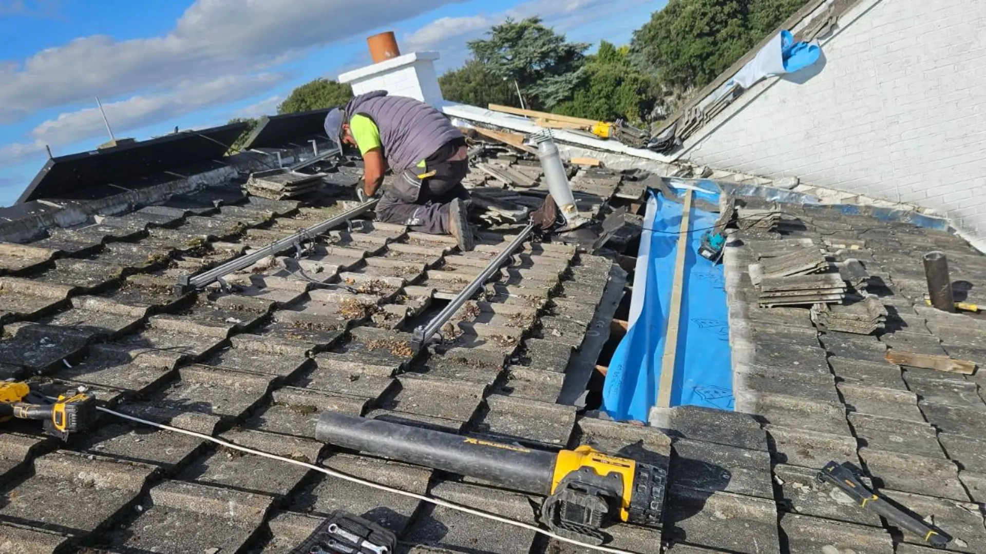 Team installing new roof shingles on Dublin area house as part of roof repair