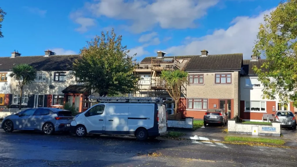 Safety harnessed roofer checking roof structure before repair work begins